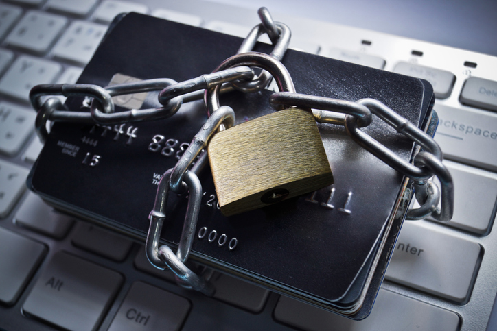 Image of credit cards locked down with a chain and padlock.